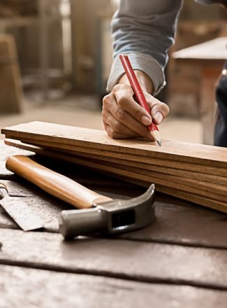 Carpenter working with equipment on wooden table in carpentry shop. woman works in a carpentry shop. Carpenter working with equipment on wooden table in carpentry shop. woman works in a carpentry shop.